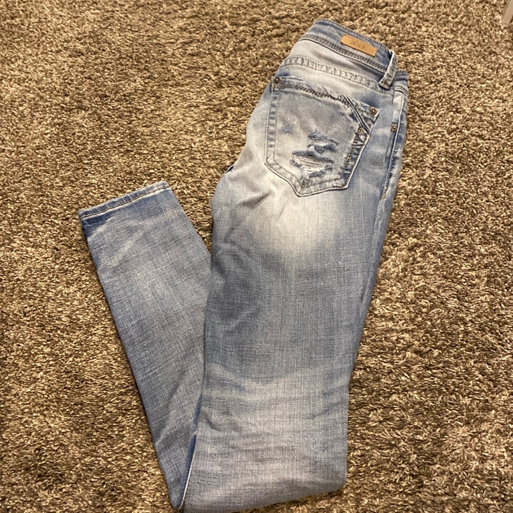 Buckle distressed skinny jeans